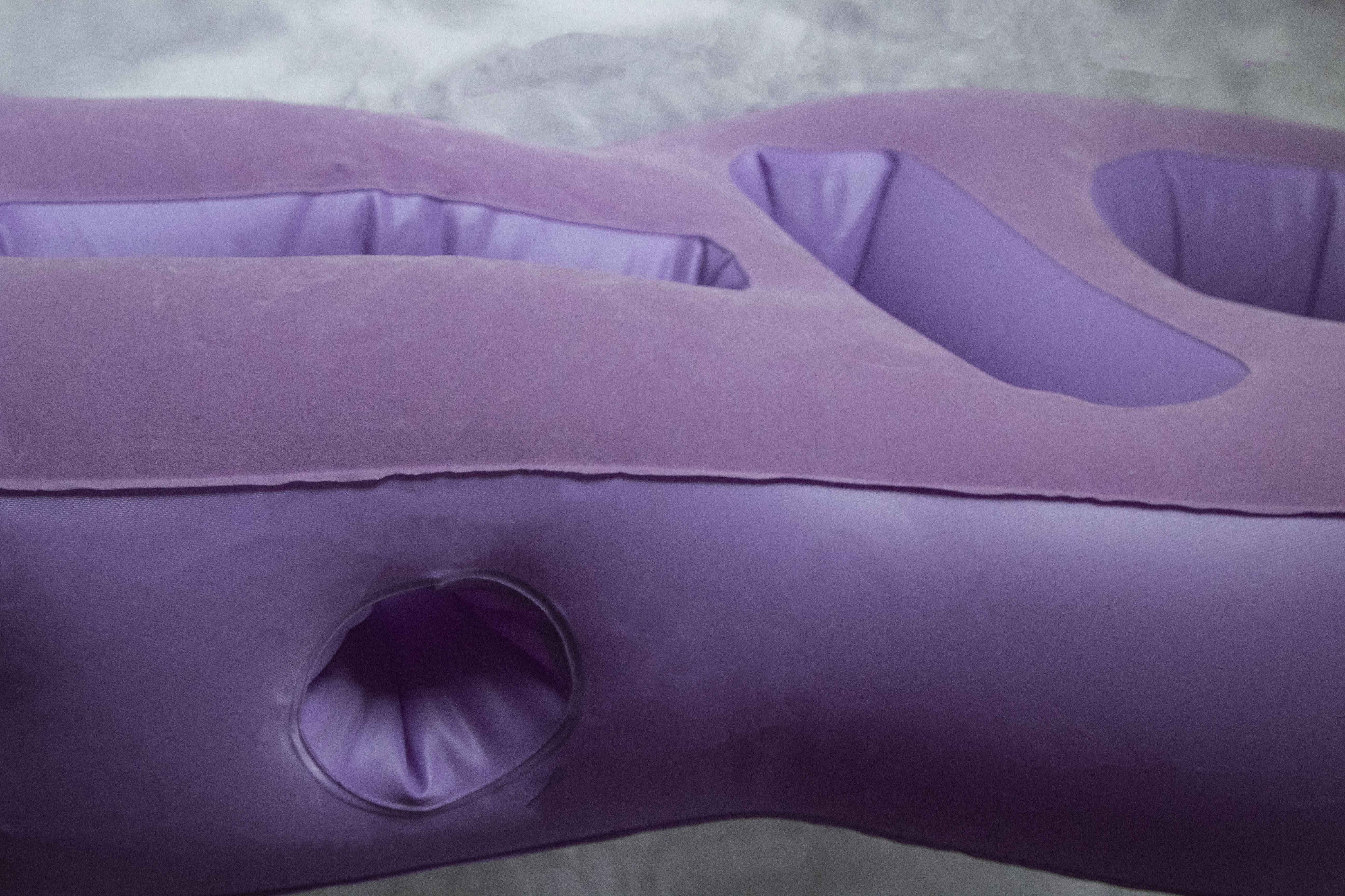 A purple, inflatable pregnancy pillow called Tummy Cradle, with a side ventilation system so pregnant mothers can breathe face-down.